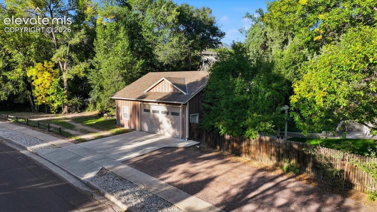 Detached garage structure featuring a two-car garage door, Secure RV parking (with bollards)