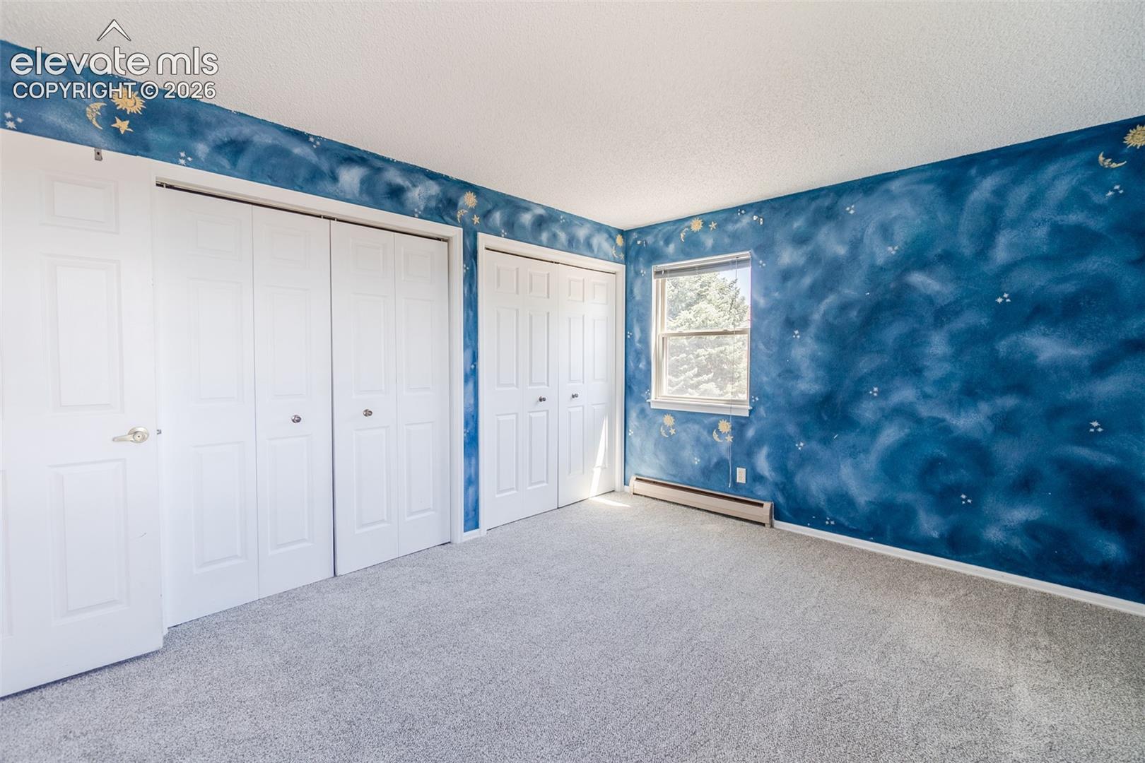 Two of Four upstairs bedroom with new Carpet multiple white bi-fold closet doors, painted walls