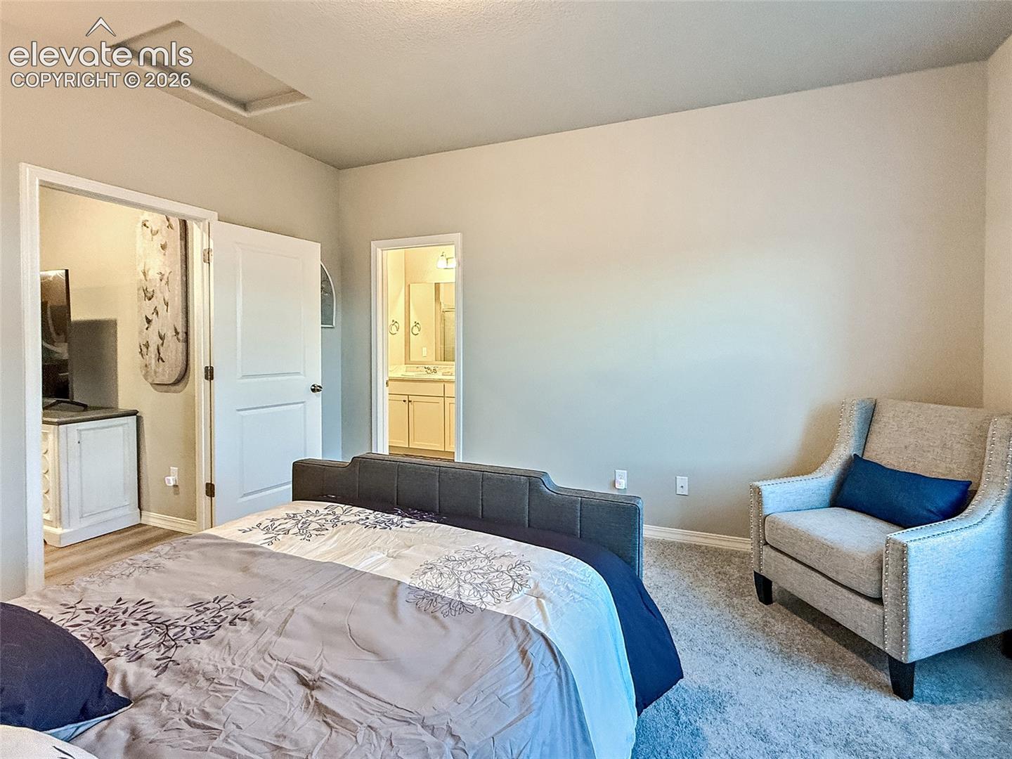 Recessed ceiling detail with neutral wall tones and plush carpeting