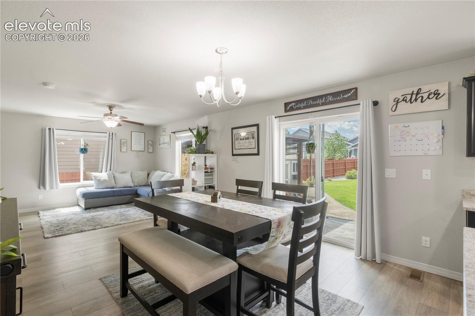 Recessed lighting, wood-finish flooring, ceiling fan, sliding glass door, and chandelier