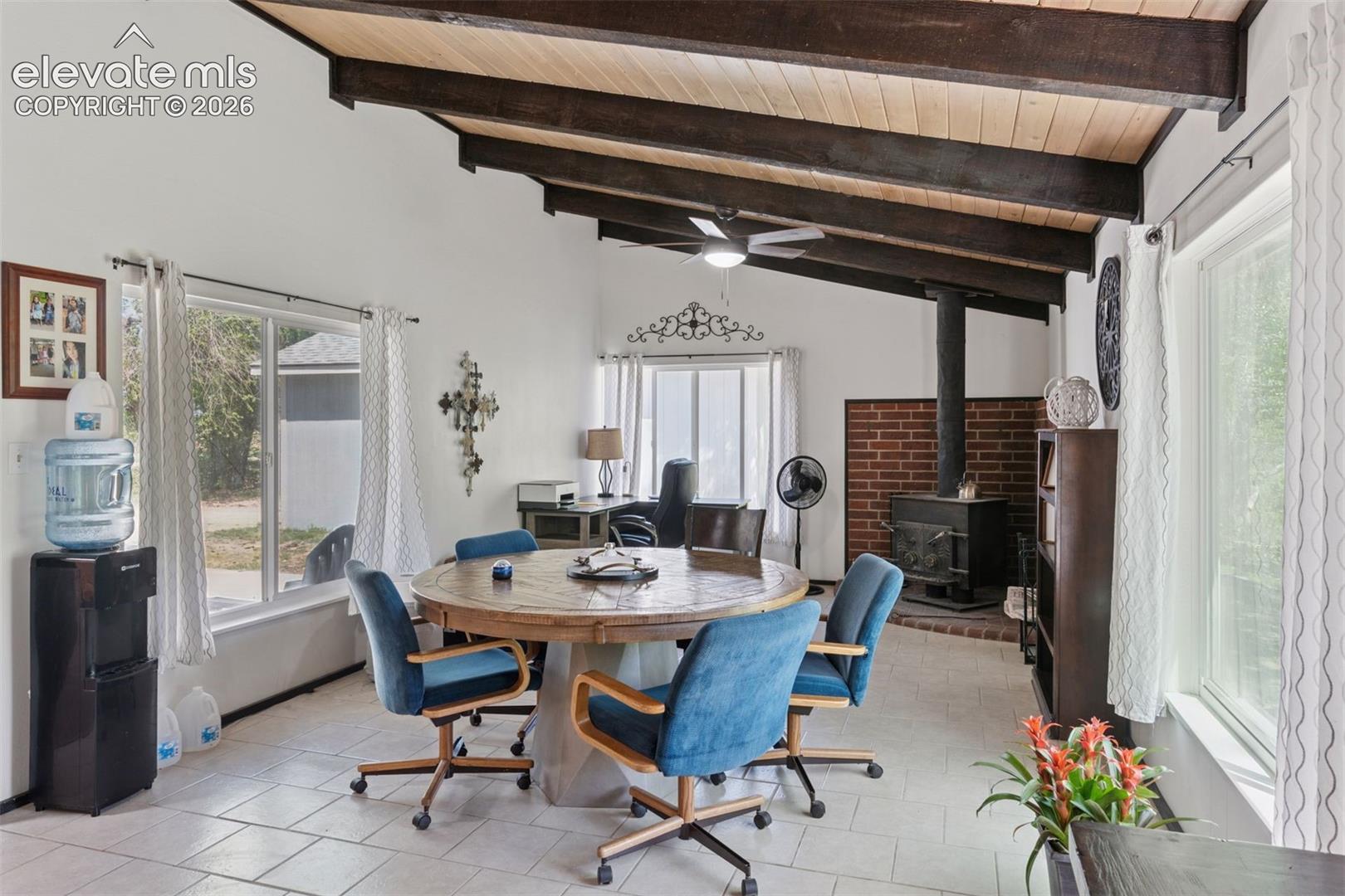 Alternate interior view of the 16885 highlighting the open addtiional living or dining area, vaulted wood ceilings with exposed beams, and natural light.