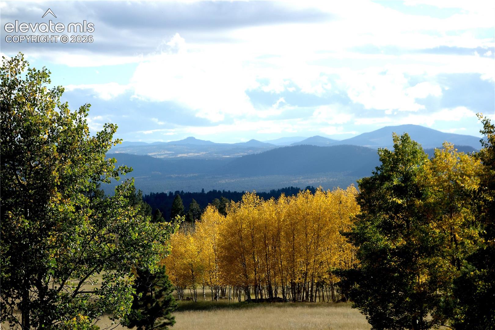 Rolling hills and distant mountains complement the expansive natural landscape