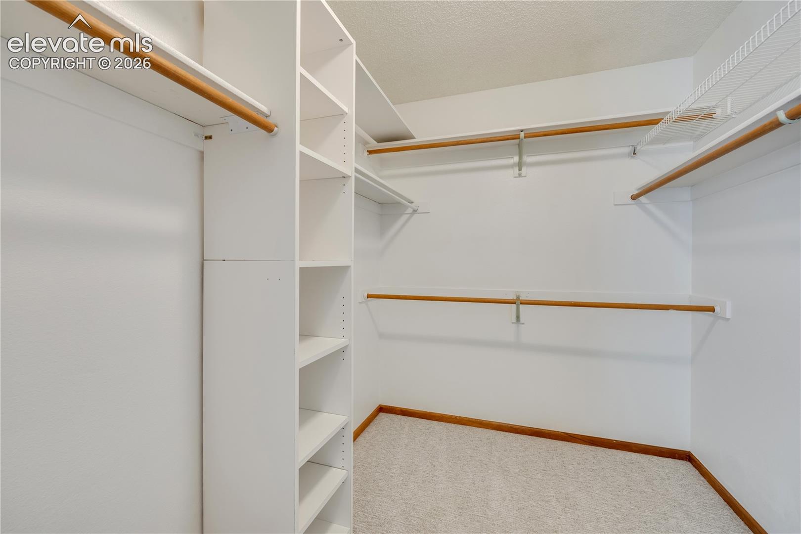 Walk in closet with shelves in master bedroom