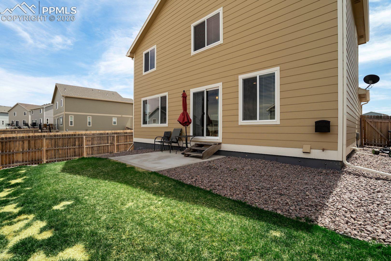 Rear view of property with a patio, a fenced backyard, and entry steps