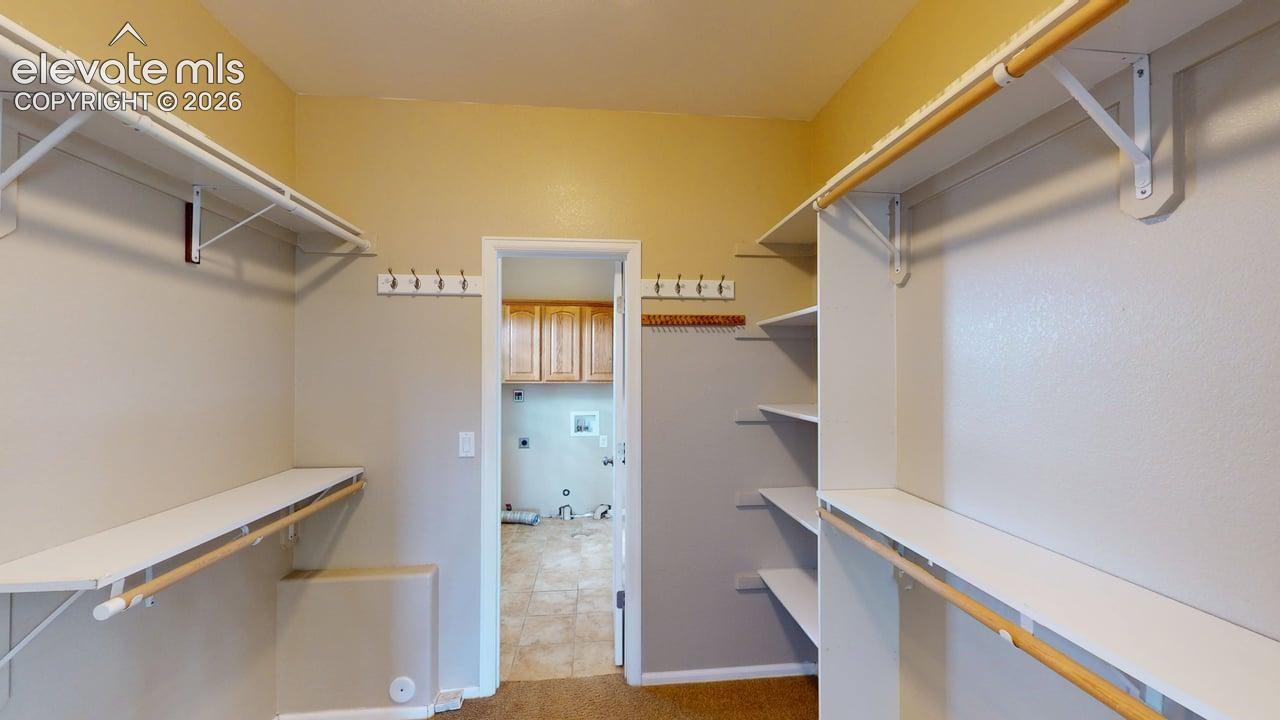 Walk-in closet with integrated shelving and hanging rods
