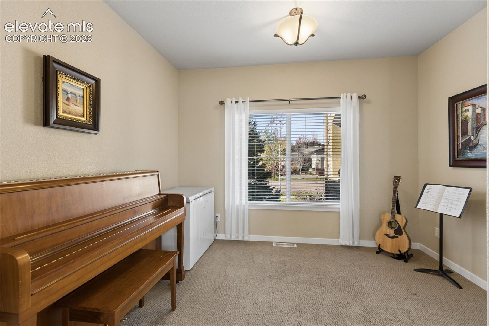 This extra room off the kitchen can be a sitting, music or dining space