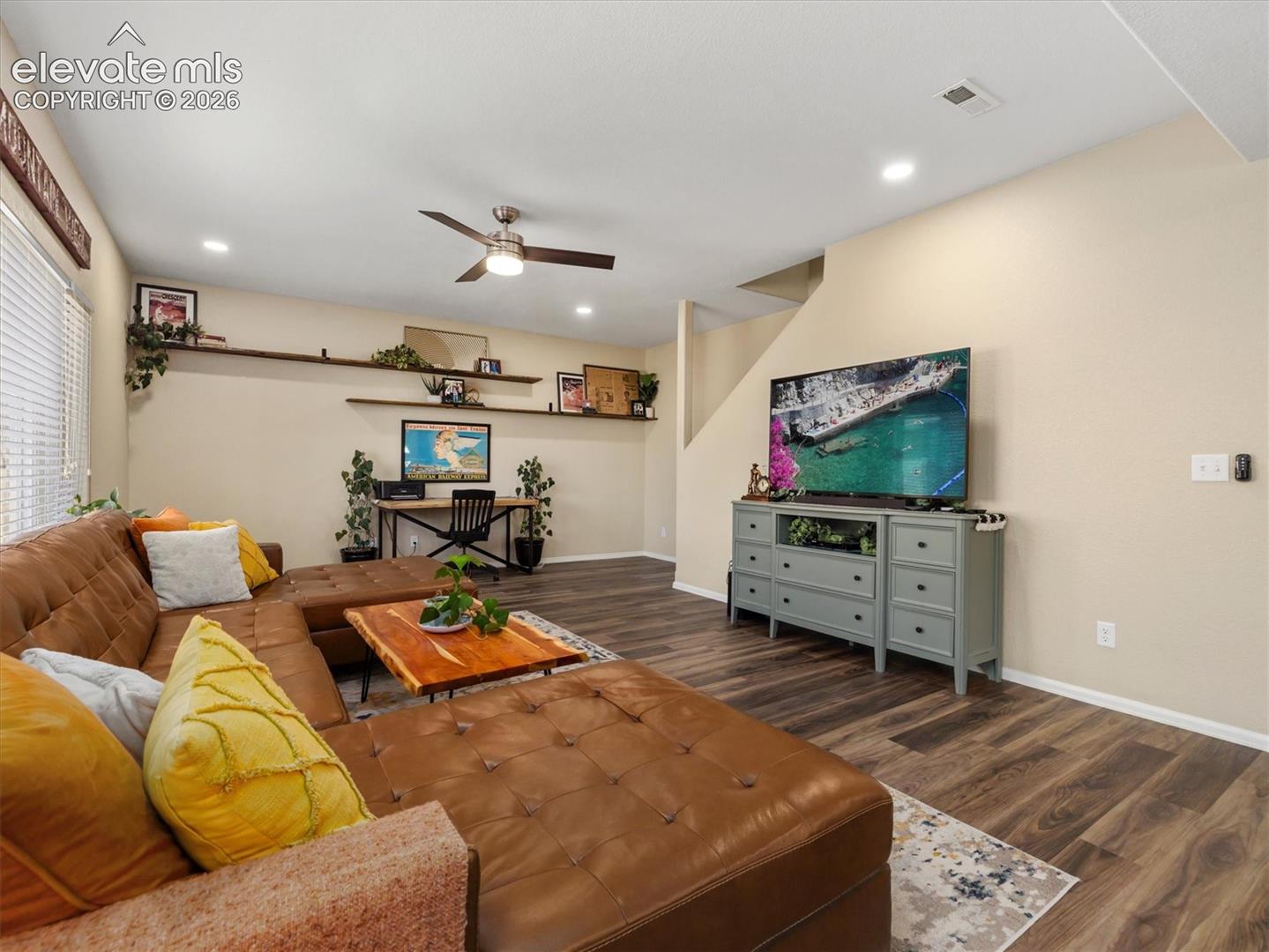 LVP flooring, recessed lighting, ceiling fan, and wall-mounted shelving