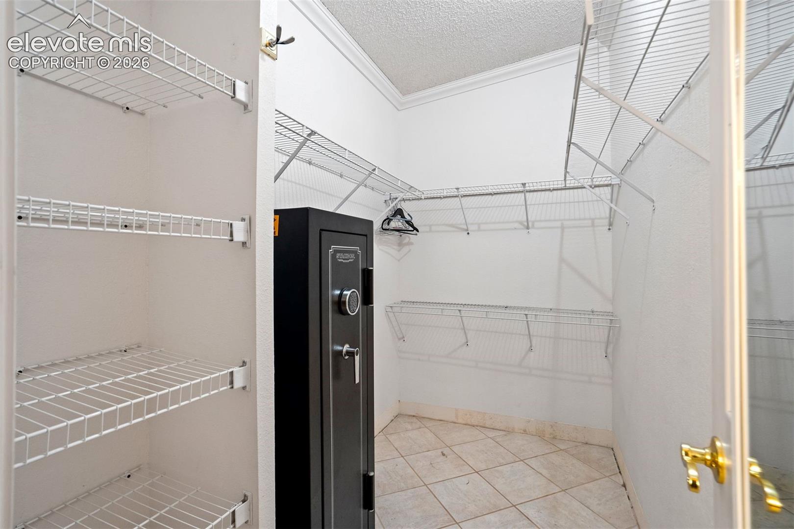 Spacious walk-in closet provides extensive shelving and organized storage options.