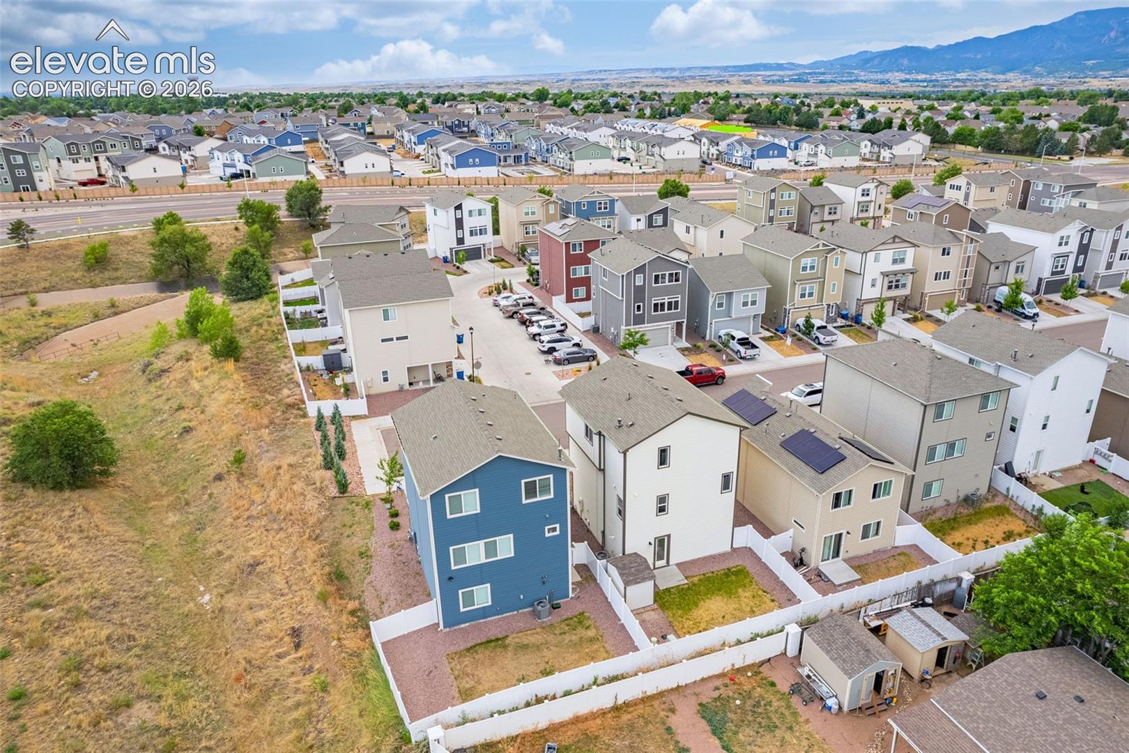 Aerial perspective of a contemporary residential development featuring multiple detached homes with varying architectural styles