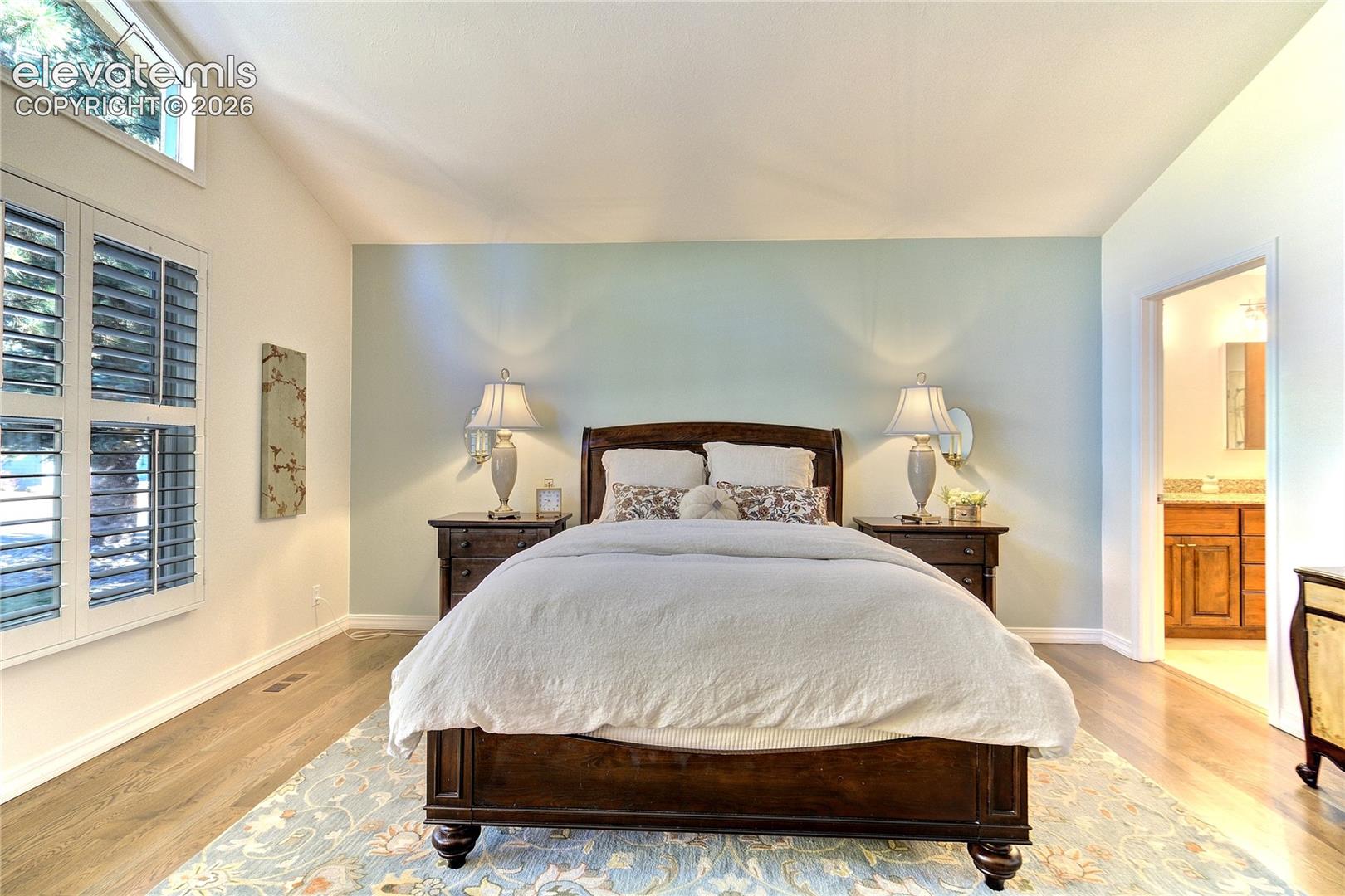 A serene main-level retreat filled with natural light + the warmth of hardwood flooring.