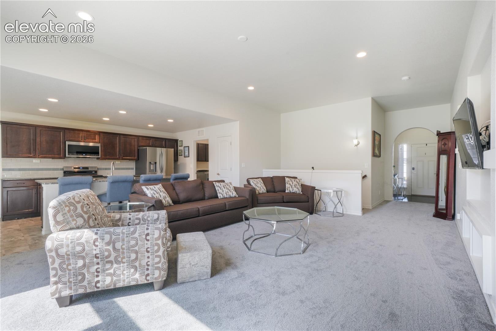 Livingroom with open concept, gas fireplace, large patio sliding doors and new carpet
