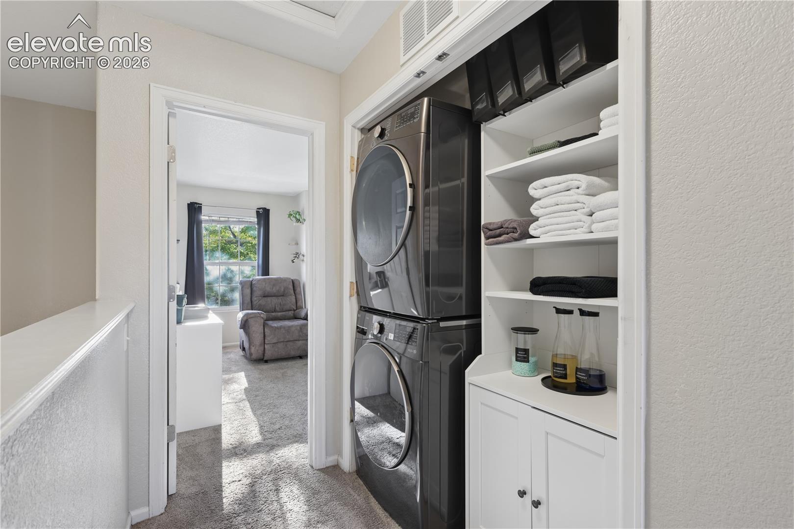 Upstairs laundry located between the two bedrooms