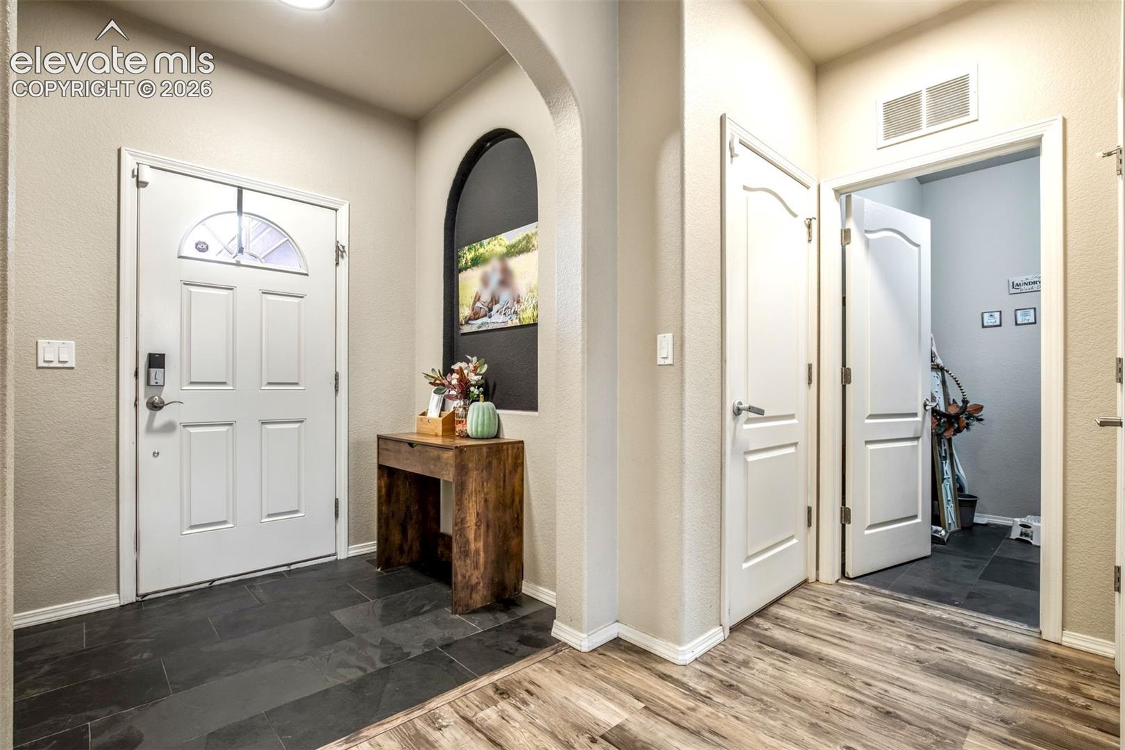 Door to the garage, coat closet and laundry to the left upon entering