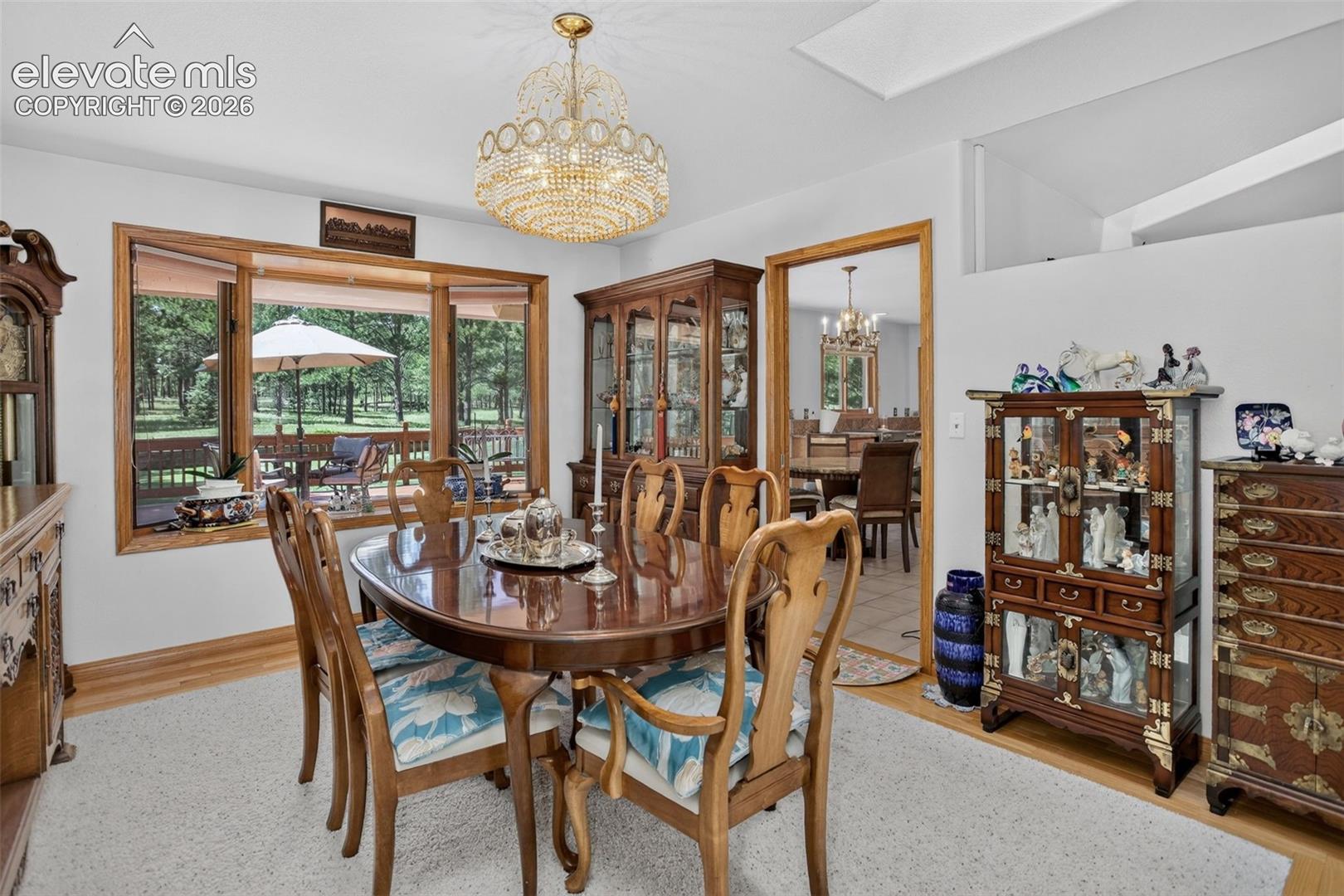 Formal dining area with skylights and access to kitchen.