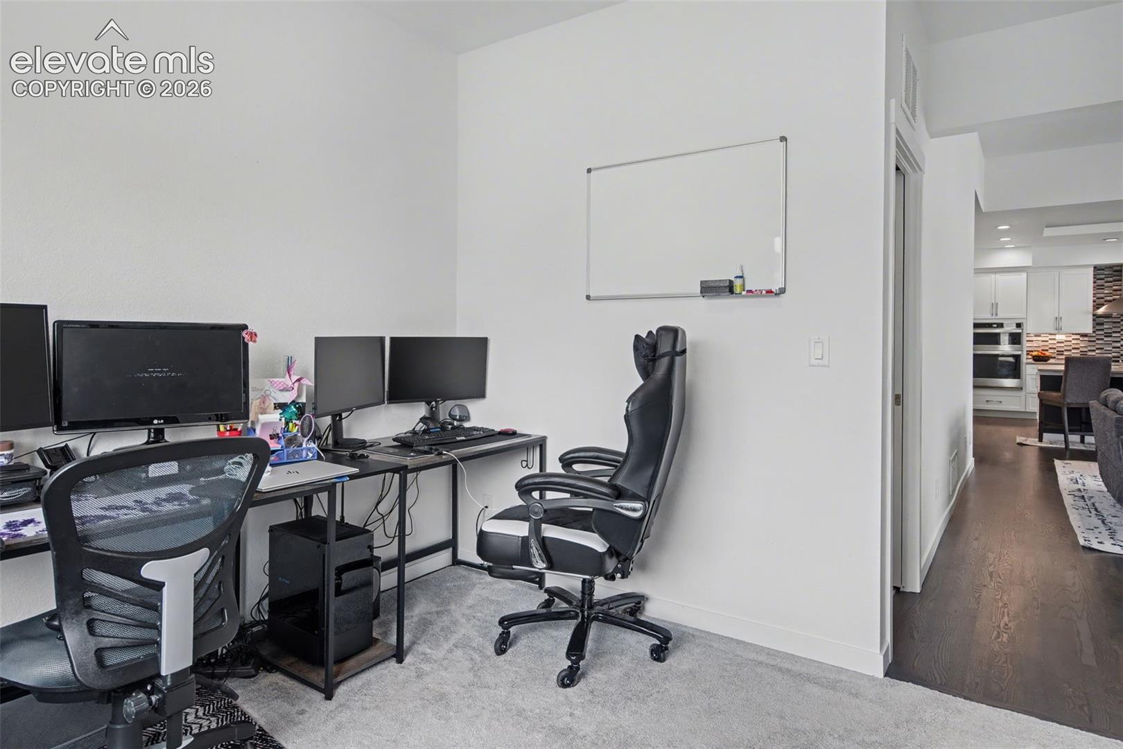 Home office with carpet flooring and baseboards