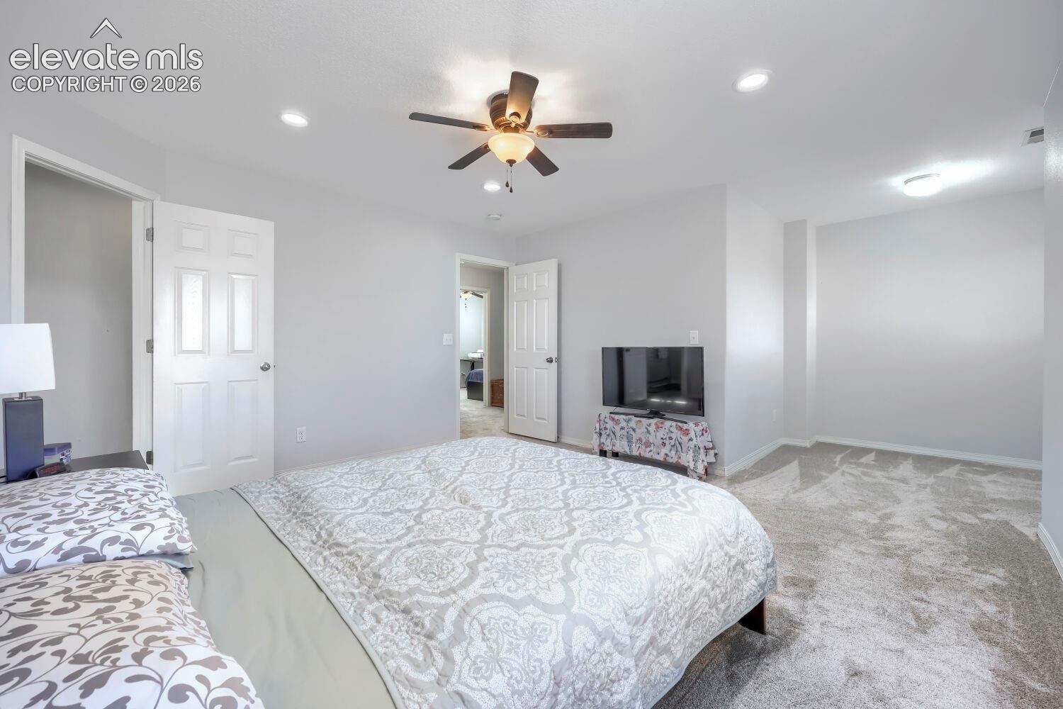 Neutral interior featuring recessed lighting, a center ceiling fan with integrated light fixture, and plush wall-to-wall carpeting