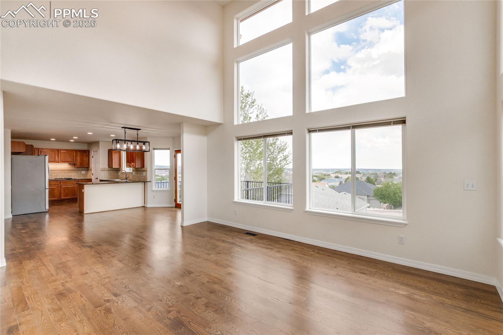 Open concept family room, view to breakfast area, and kitchen.