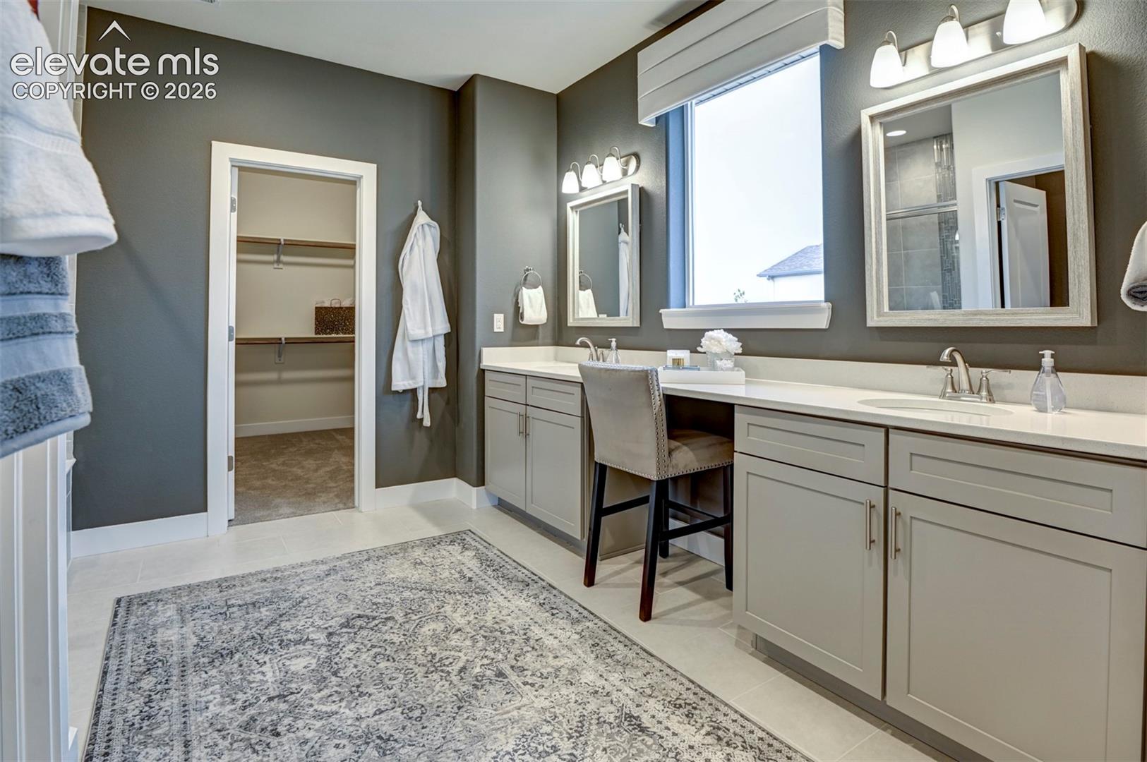 Dual vanity with light gray cabinetry, light countertops, and individual mirrors