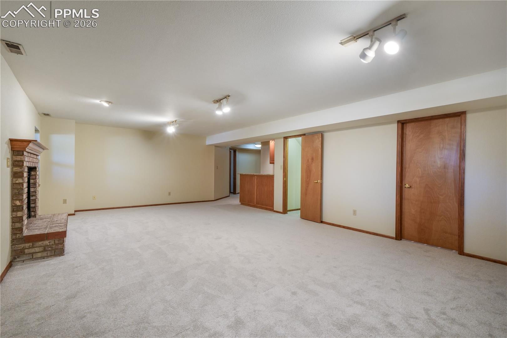 Basement family room, new carpet, views of storage room