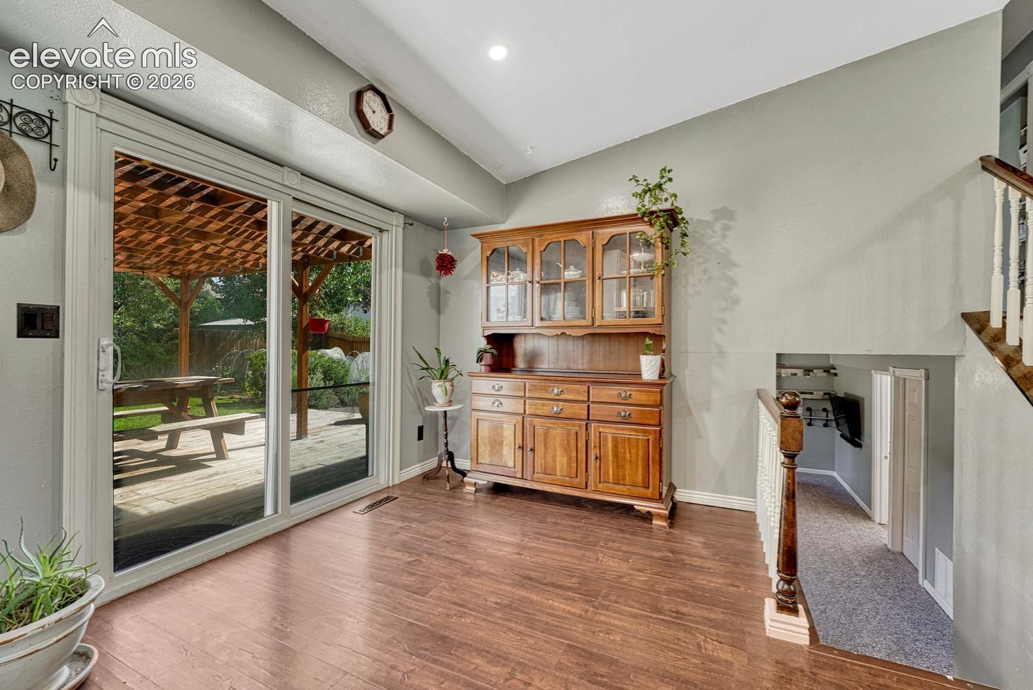 Dining Nook and slider door to the backyard deck with covered pergola.