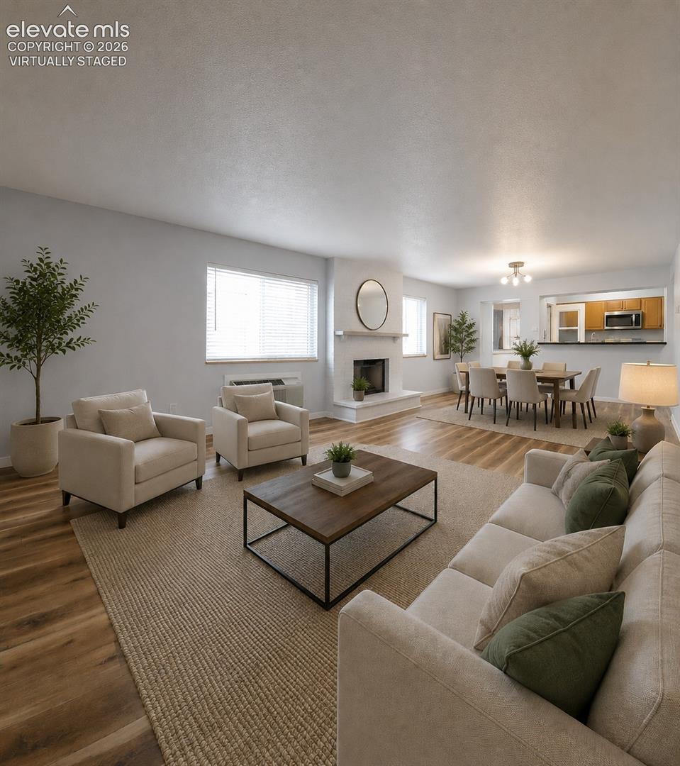 Virtually staged Spacious living area featuring wood-finish flooring throughout