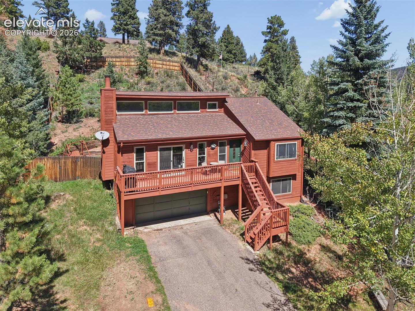 Two-story residence with a red exterior and a shingled roof