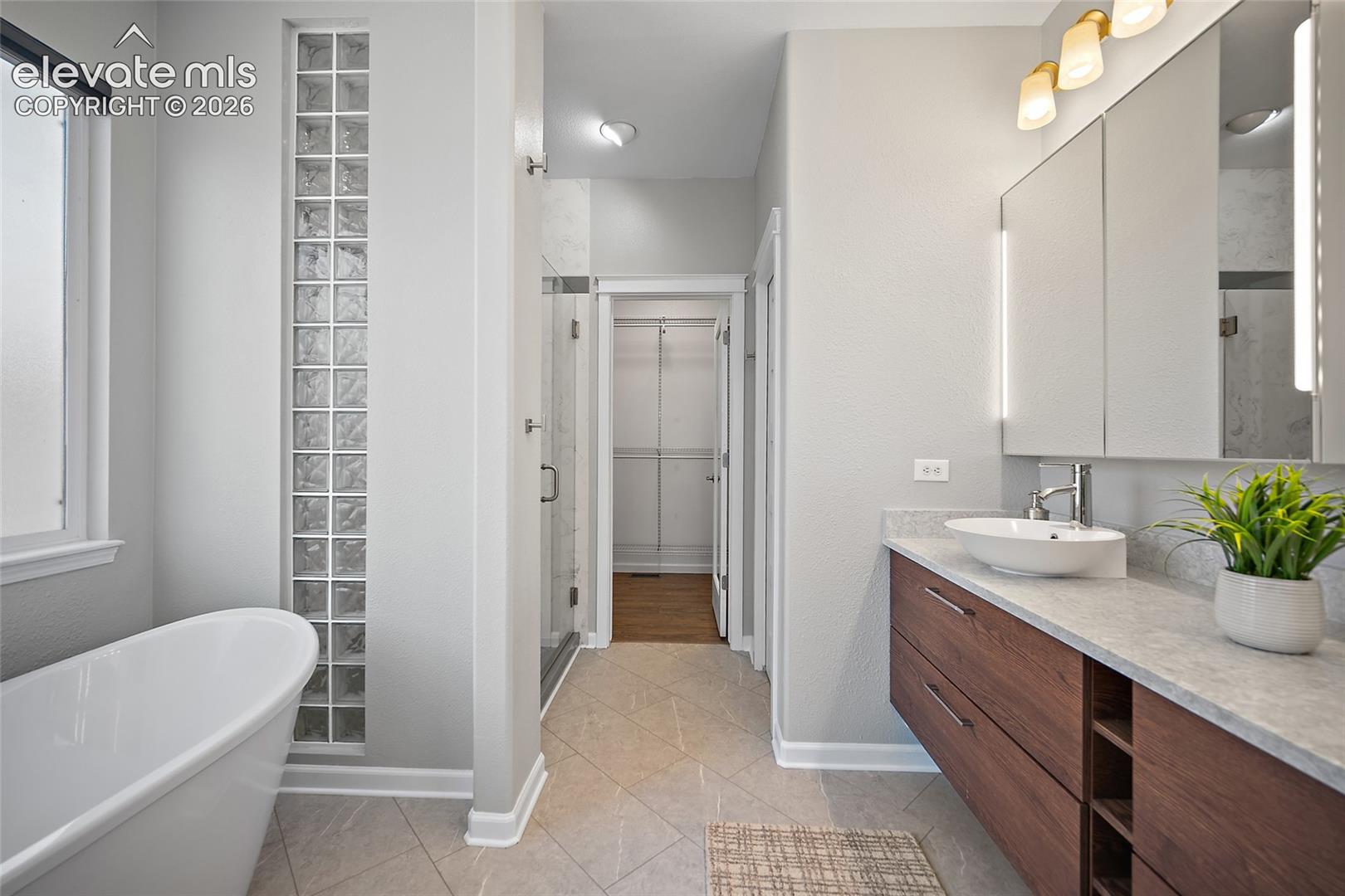 Modern tub.  Window has electric shade
