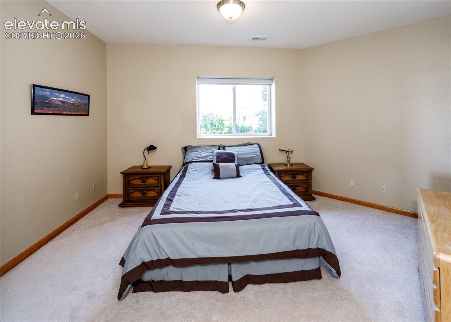 Soft neutral wall tones, light-colored carpeting, and natural wood baseboards