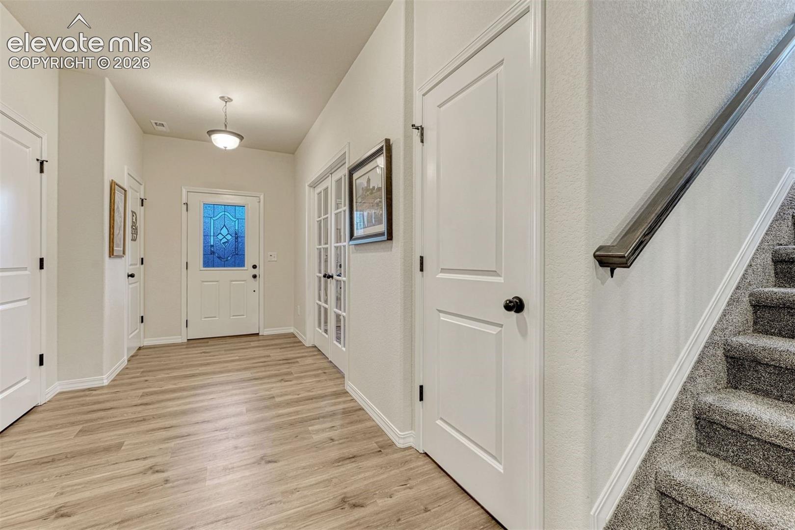 Greeting guest in this large entry with half bath