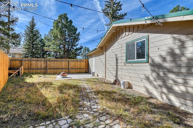 Fenced backyard featuring a patio area and an outdoor fire pit