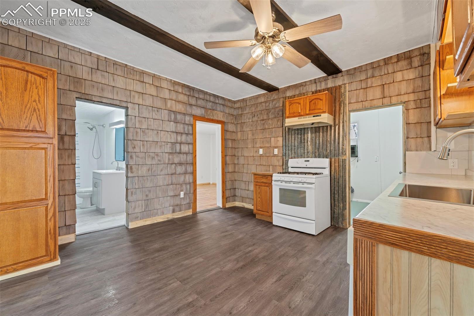 Kitchen with access to main bathroom (left), Primary Bedroom, and Laundry Room/Half Bath