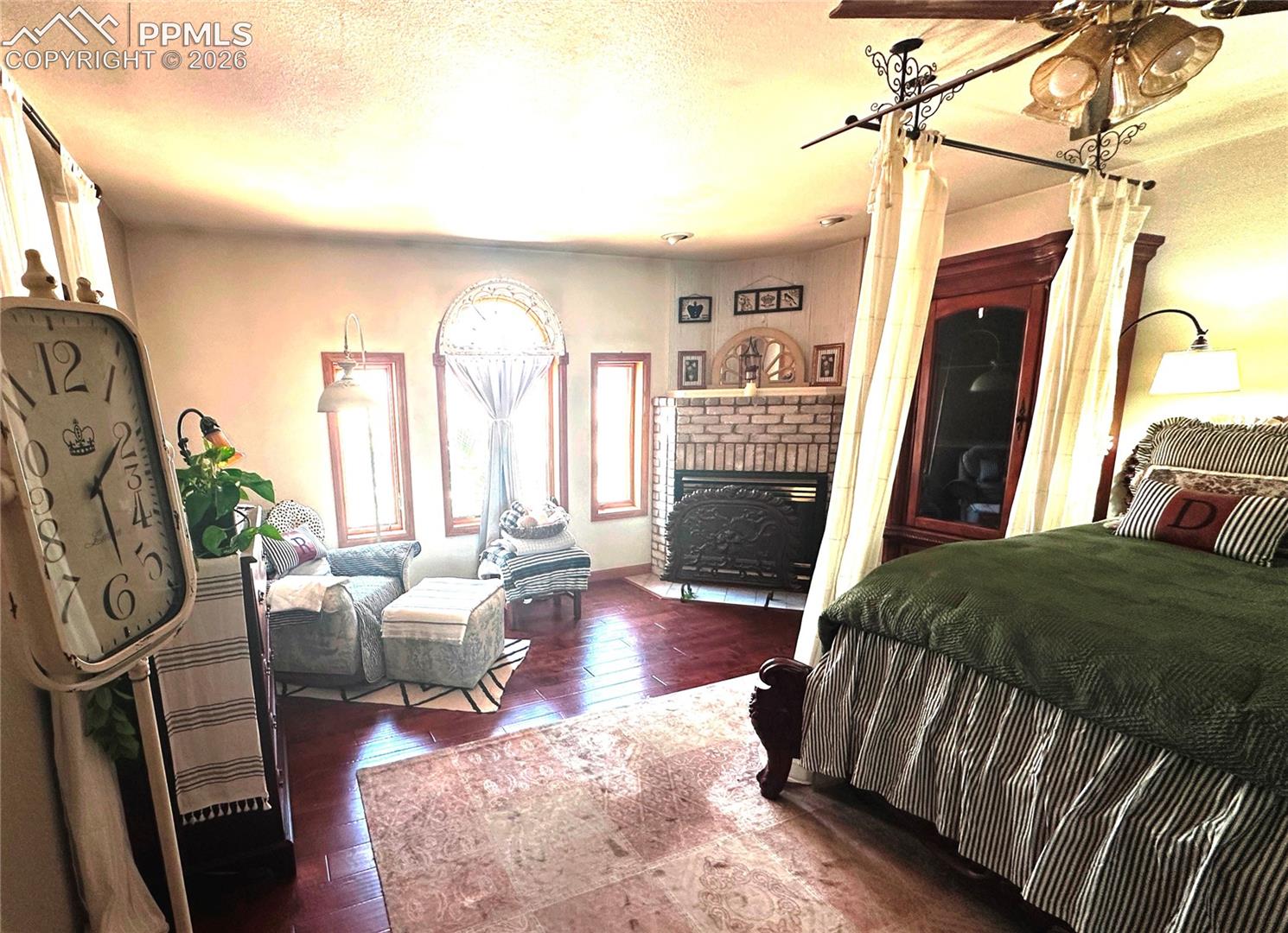 Primary bedroom with propane fireplace at the top and sitting area to the left.