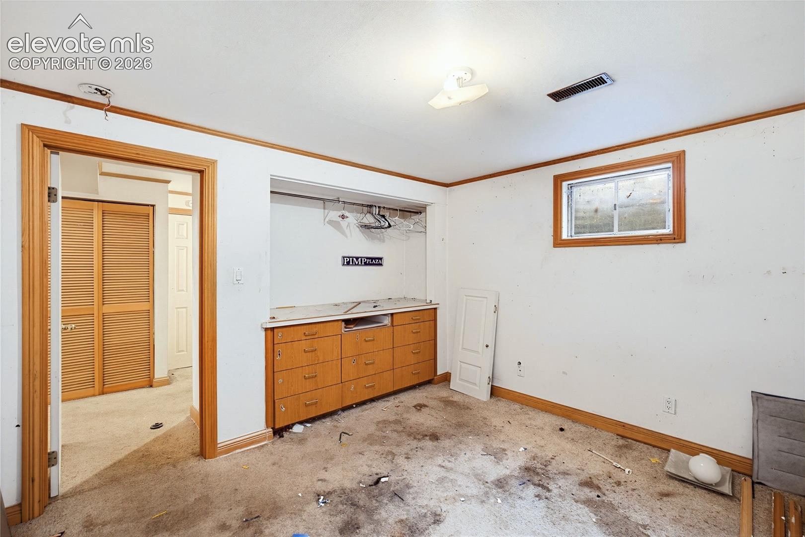 Built-in cabinetry with multiple drawers and a countertop, wood-finish trim, and a window for natural light