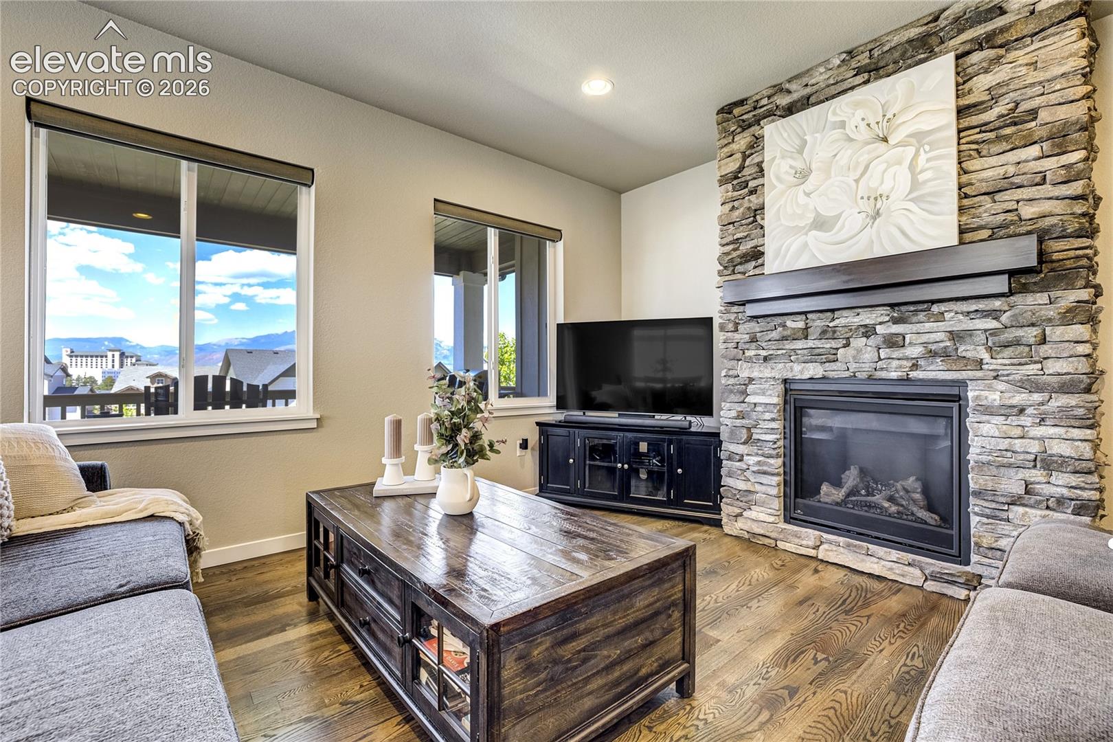 Gather Naturally | 
A stone fireplace, expansive windows, and open-concept design create the perfect space to connect and unwind.