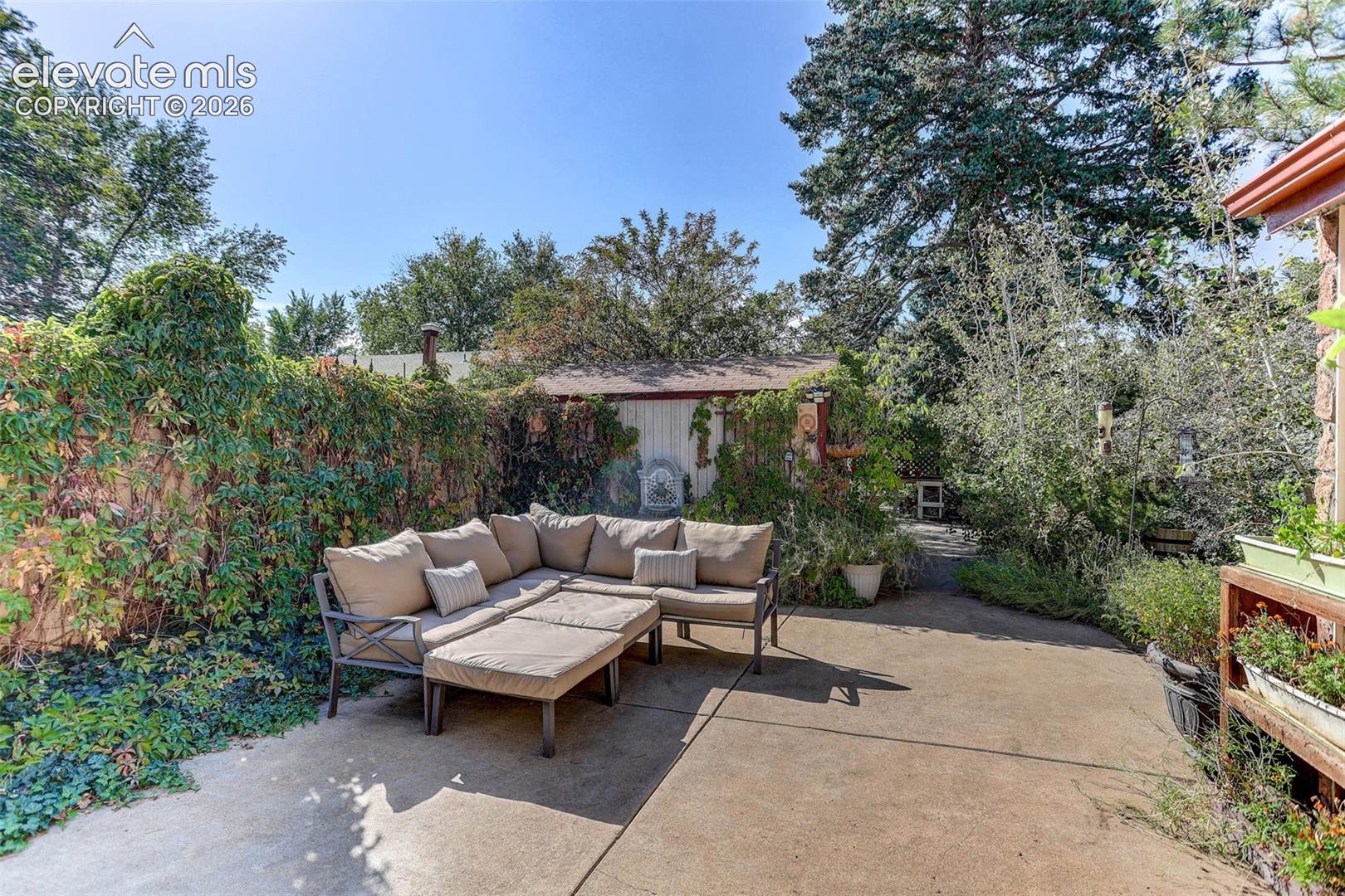 Paved patio area, established perimeter landscaping, mature trees