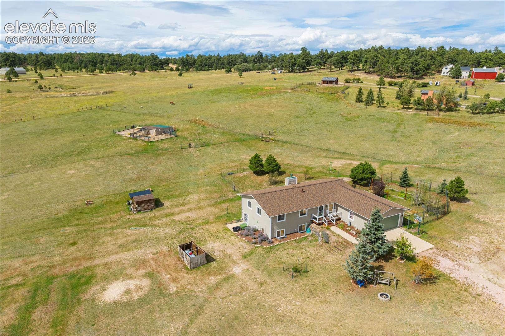 Welcome to this exceptional horse property in River’s Divide, offering peaceful Colorado living, open space, and beautiful natural surroundings. Set among the rolling hills of Peyton, this property combines country living with a spacious and versatile ranch-style home.The home features 4 bedrooms and 3 full bathrooms with an inviting open-concept main level, vaulted ceilings, breakfast bar, fireplace, and plenty of natural light. The dining area offers a walkout to the elevated deck, creating an easy transition to outdoor living and a great spot to relax, entertain, or enjoy the peaceful surroundings. The primary suite features a private full bathroom, while two additional bedrooms, another full bathroom, and the laundry room are all conveniently located on the main level.The walkout basement provides an impressive amount of additional living space with two separate family/living areas, a fourth bedroom, and a full bathroom. The flexible layout offers plenty of possibilities for a media room, game room, home office, exercise space, guest area, or additional gathering space. The basement is finished with the exception of flooring throughout, allowing the next owner to select flooring that complements their own style.The property is set up for horses with a 24x24 outbuilding featuring a two-stall stable, tack room, hay storage, and water, along with open acreage to enjoy. A fenced garden area provides dedicated space for gardening and adds another great way to take advantage of the property’s outdoor setting.Additional features include an attached garage, excellent mechanical systems, and a backup generator wired to the main electrical panel. With generous indoor and outdoor living spaces, horse facilities, usable acreage, and a peaceful setting, this River’s Divide property offers a wonderful combination of space, versatility, and country living