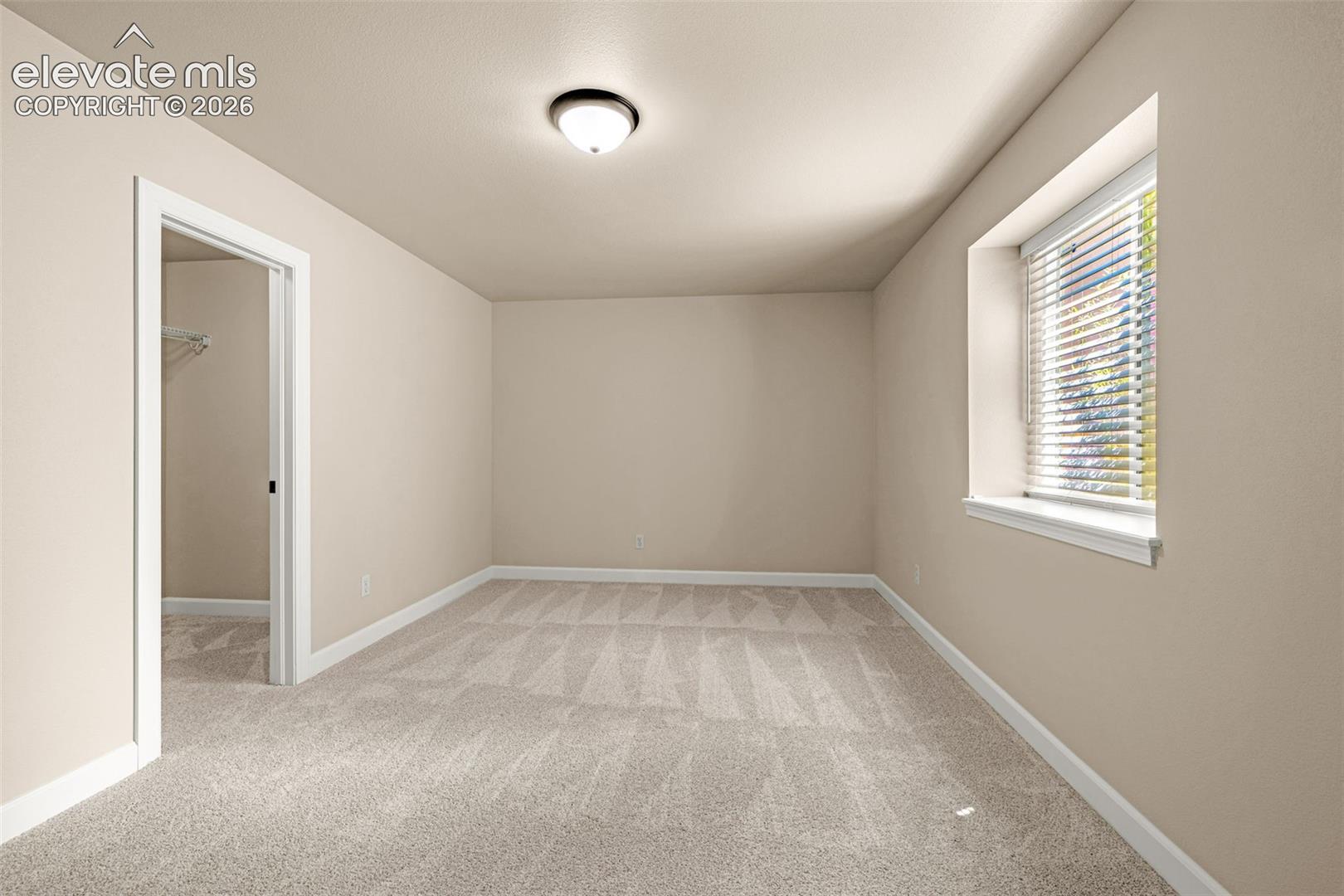Lower level Bedroom 5; new carpet, new baseboards, new lighting, new blinds and a large walk-in closet.  Great for overnight stays.