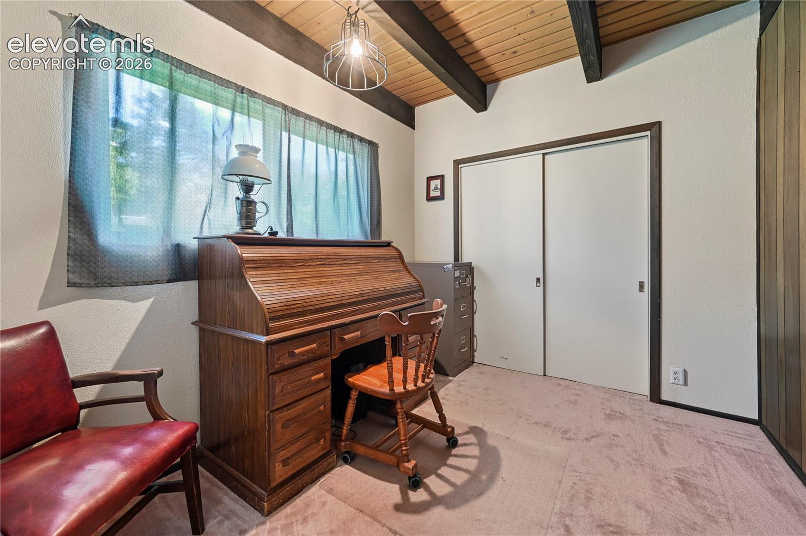 Vaulted wood-paneled ceiling with exposed beams