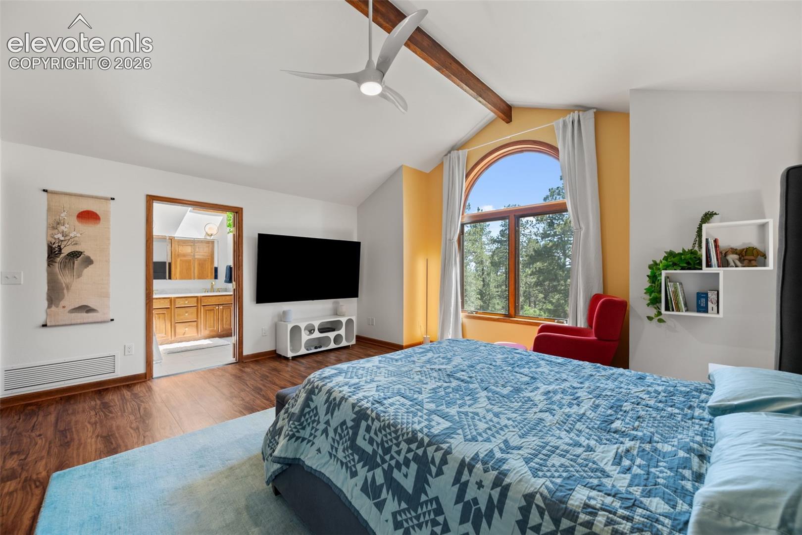 Vaulted ceiling with exposed wood beam and contemporary ceiling fan