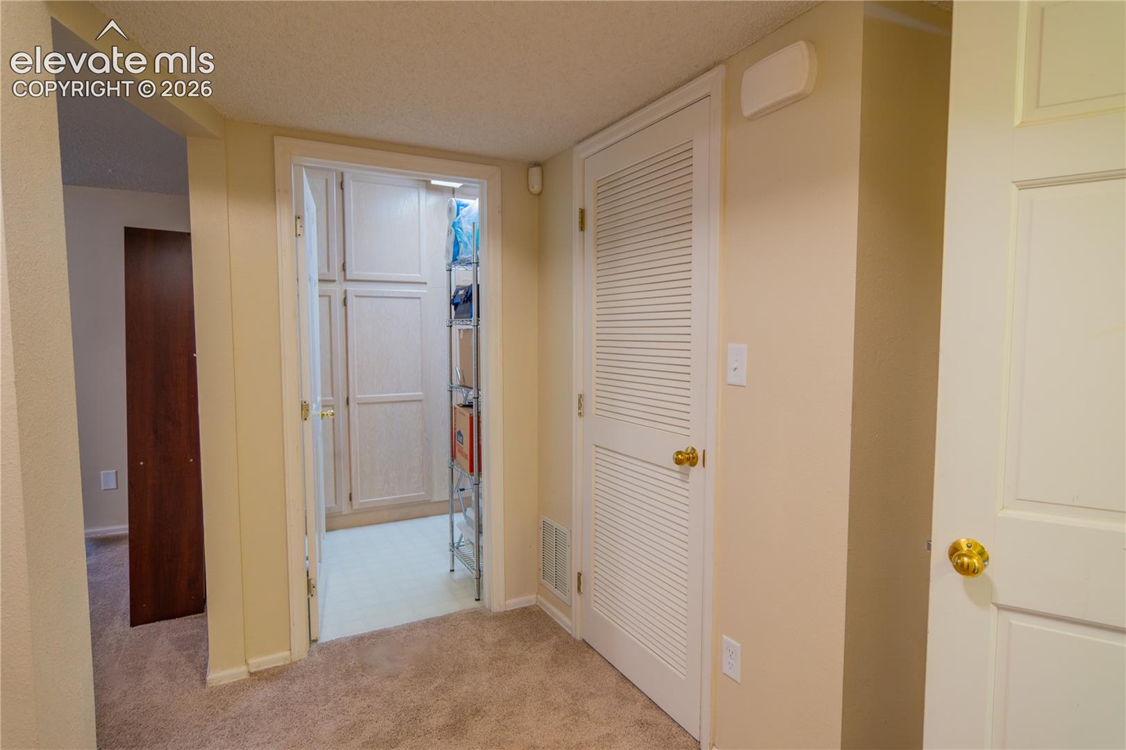 Built-in cabinetry within a dedicated storage area, solid core interior doors, and neutral wall tones