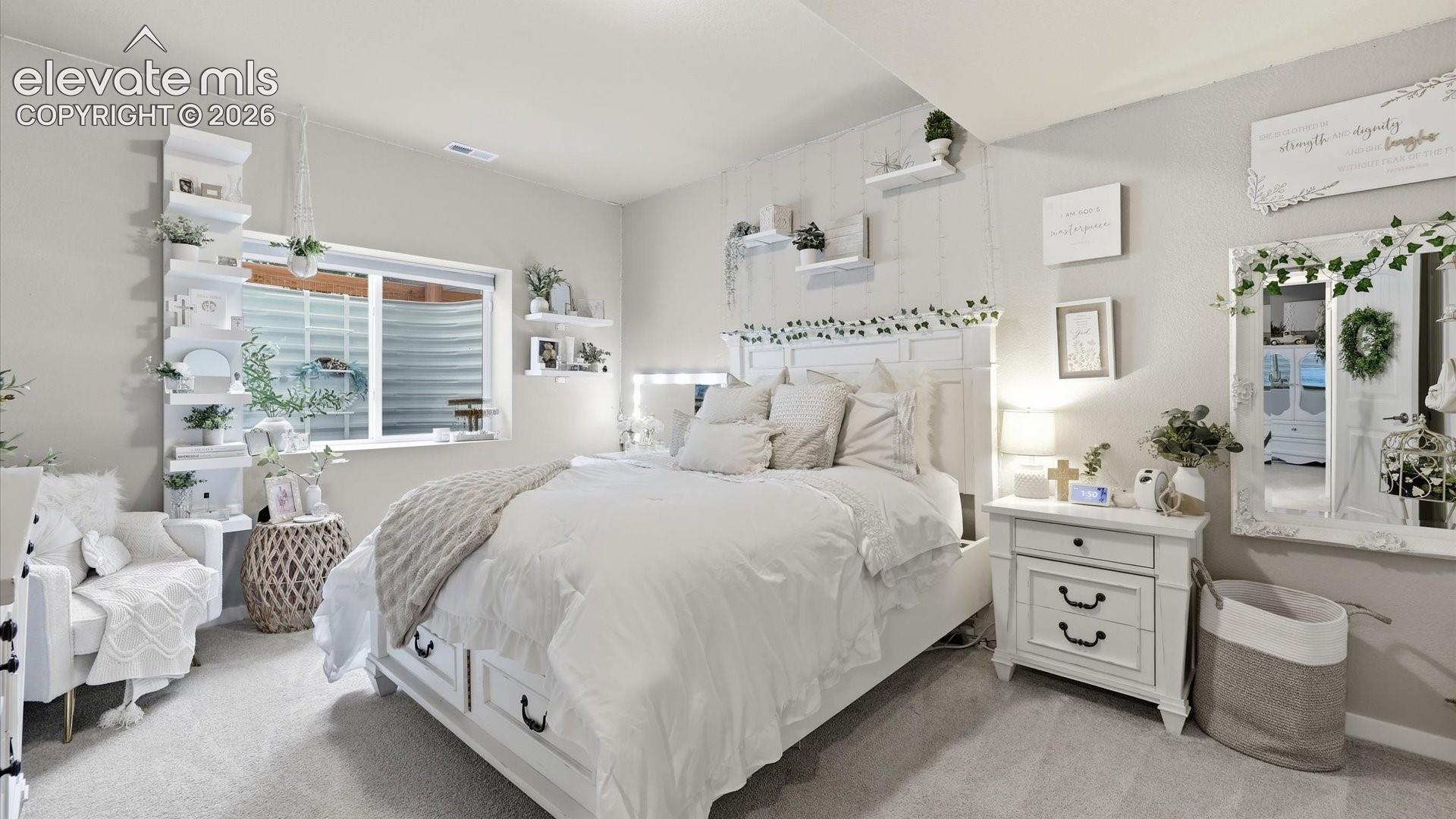 SPACIOUS & SERENE — A generously sized lower-level bedroom offers a peaceful, comfortable retreat with plenty of room to make the space your own.