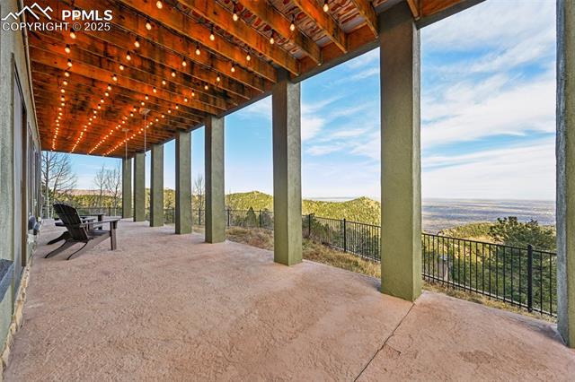 Covered patio off the lower level with dog run