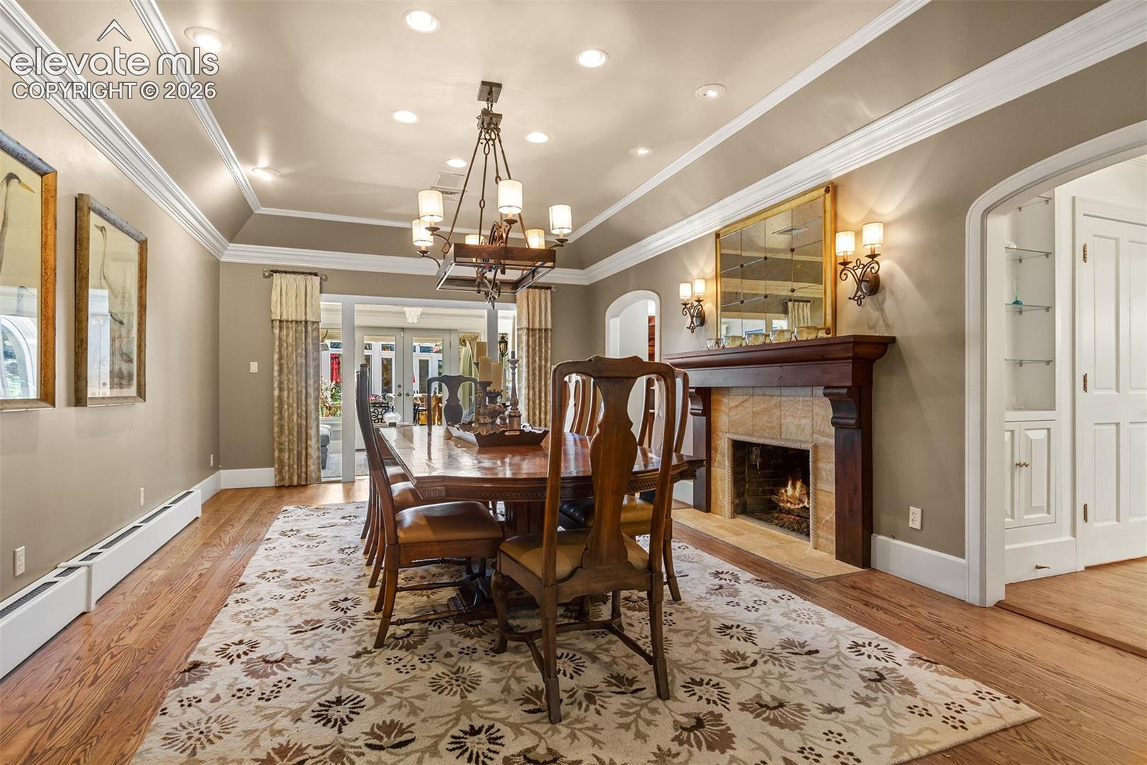 Formal dining room with an entry to the sun room and 10 ft ceilings.