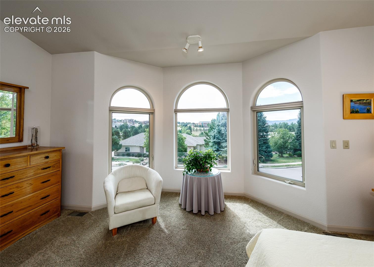 Very bright primary with sitting area and walk-in closet.