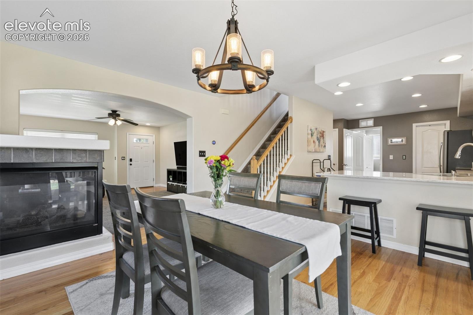 Hardwood-finish flooring, recessed lighting, and a kitchen island with seating
