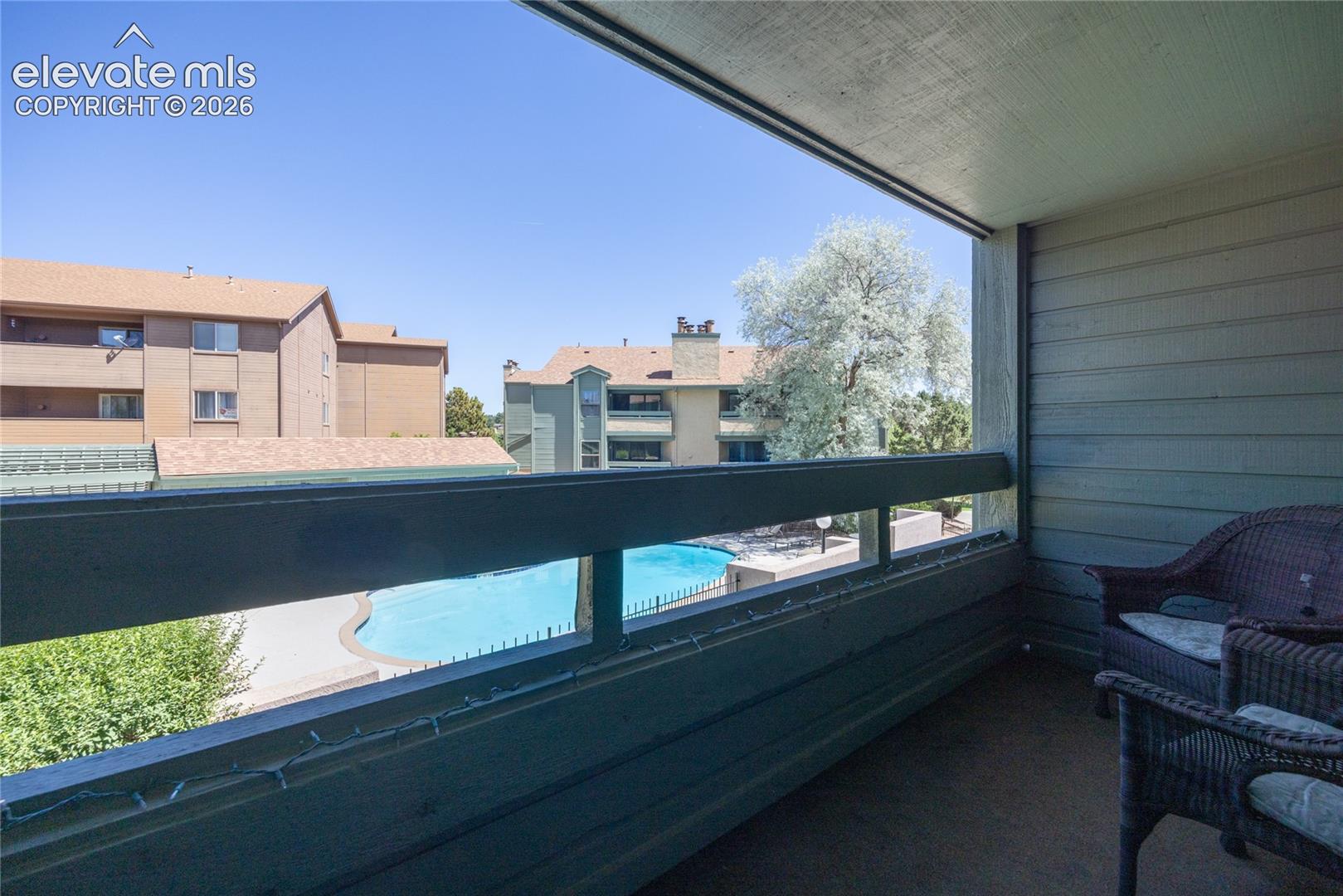 Balcony overlooks the pool area.