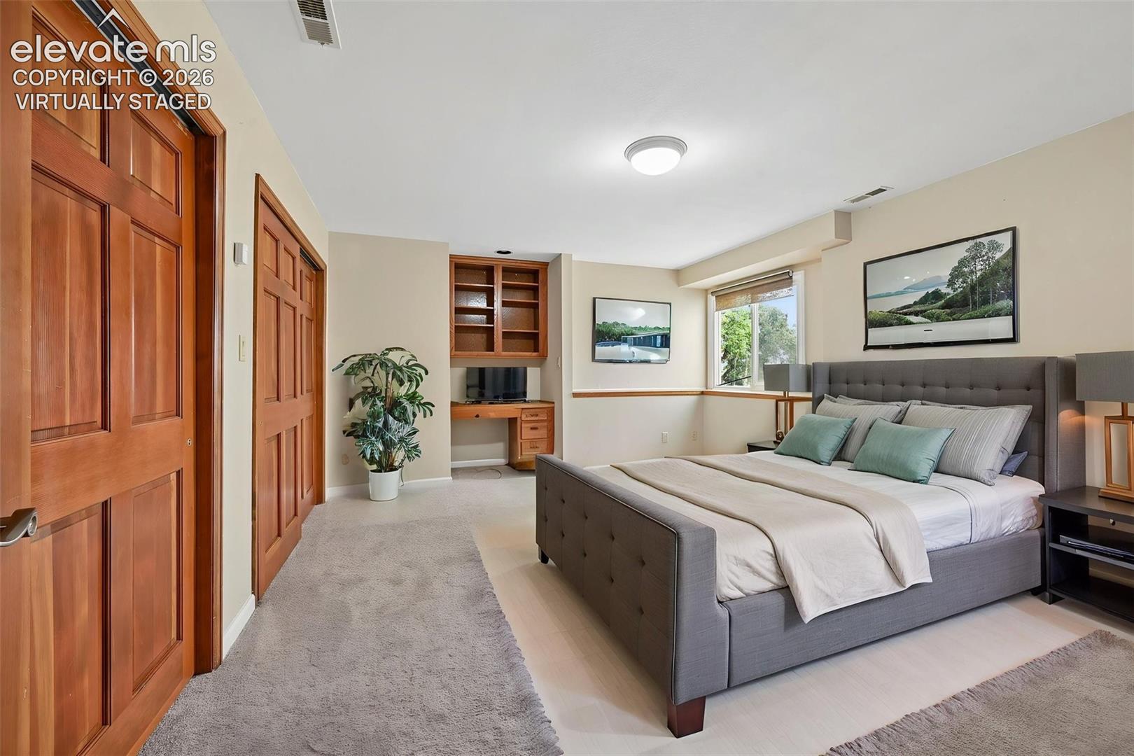 Virtually staged basement bedroom could be used as an office or craft room, as it already has built in shelving and desk!! 