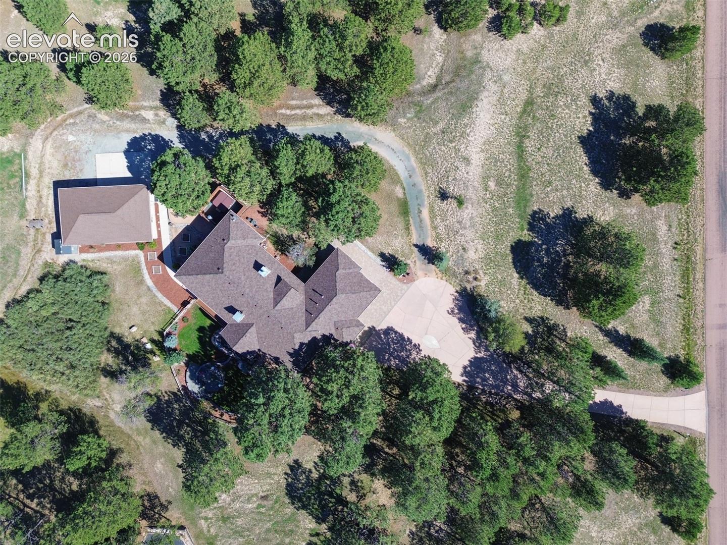 Notice the sep driveway that goes around the house to the detached garage with a walkway to the separate basement entrance