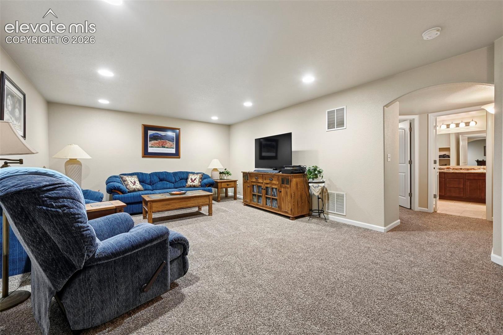 Large Family room with recessed lighting and a neutral wall color