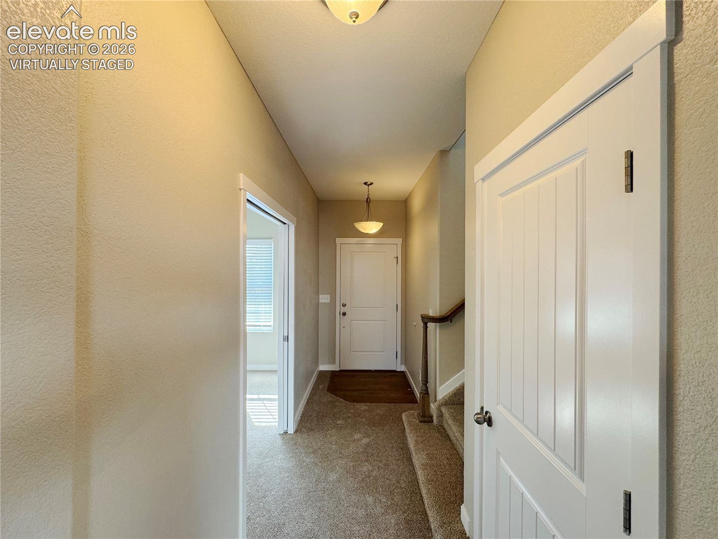 virtually staged Kitchen featuring wood-finish cabinetry, stainless steel appliances, a center island with bar seating, recessed lighting, and sliding glass doors